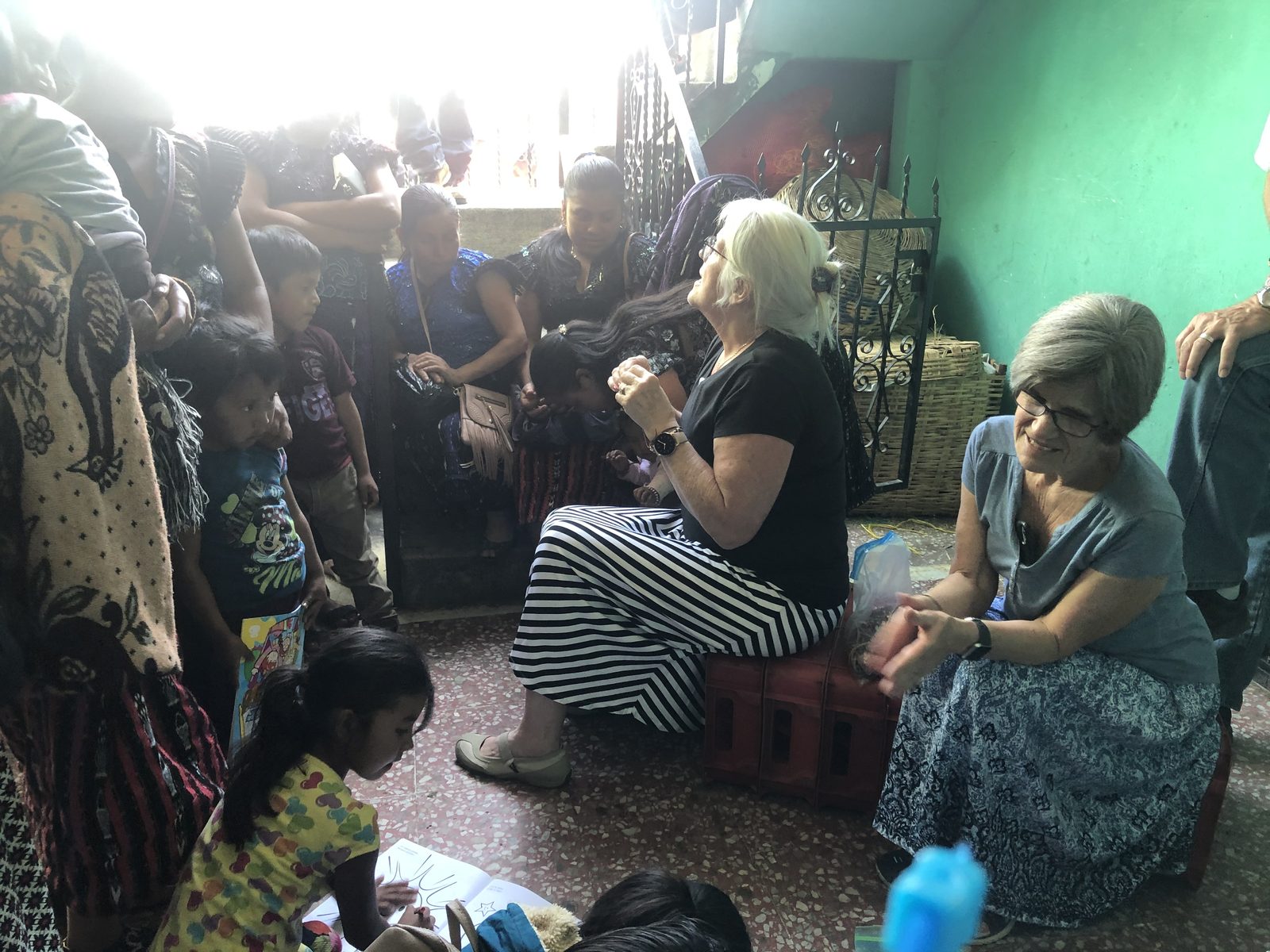 Mothers and children gathered with volunteers inside the Adonai clinic in Canillá, Guatemala